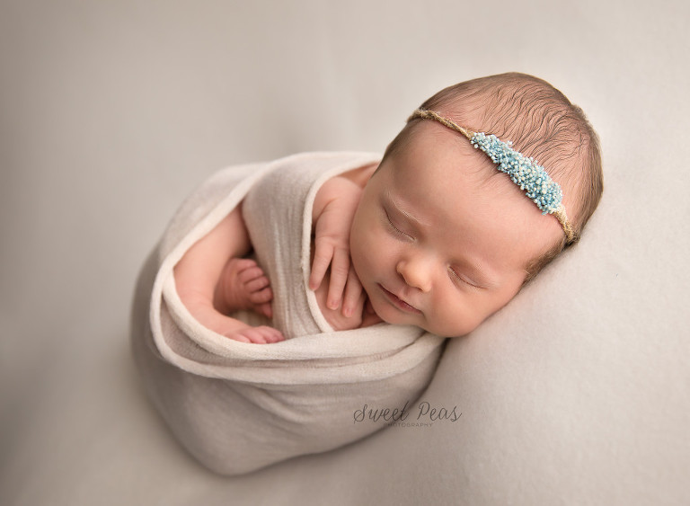 Kingman Newborn Photographer baby girl wrapped with Vanilla Lullaby tieback
