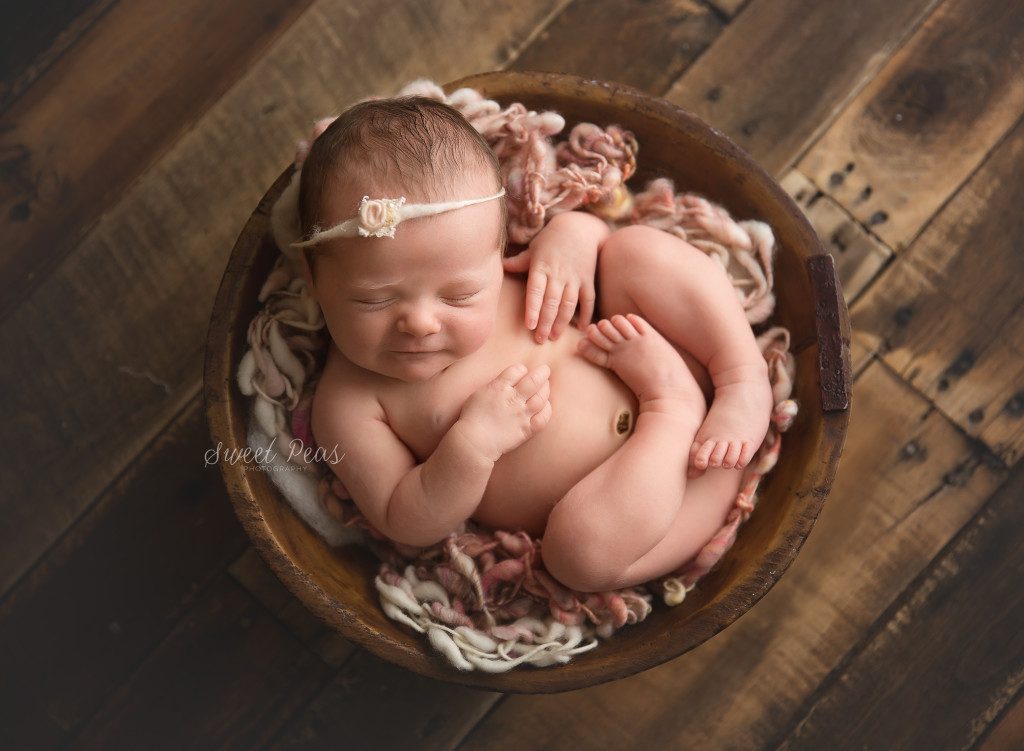 Kingman Arizona Newborn Photographer Baby Aubrey baby in a wooden bowl on a wood backdrop