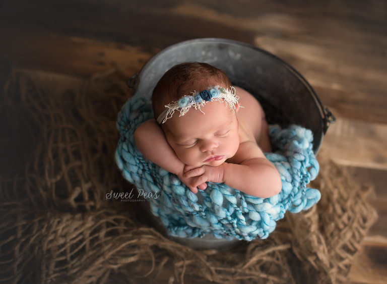 Kingman AZ Newborn Photographer Baby Rilynn newborn baby girl in bucket on wood backdrop