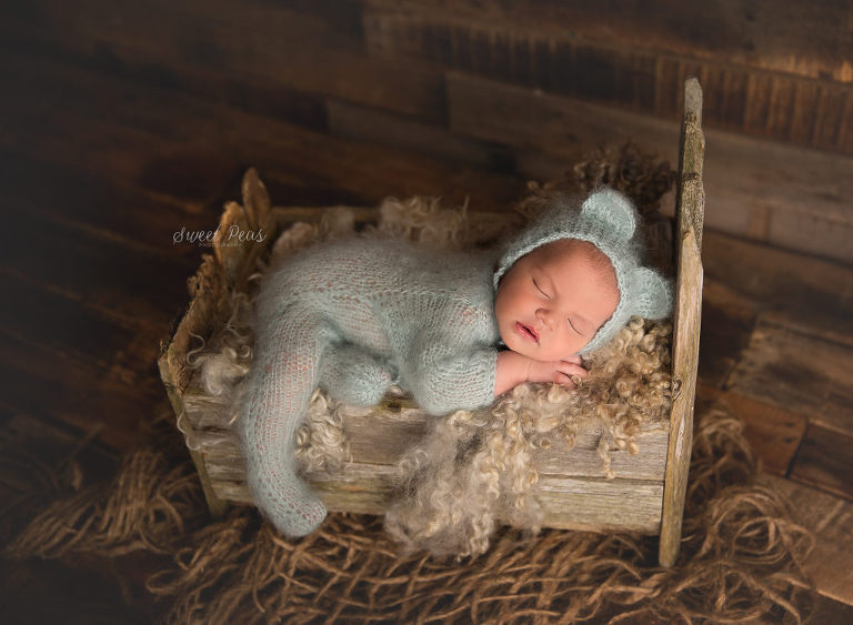 Kingman Newborn Photographer baby in barn wood bed