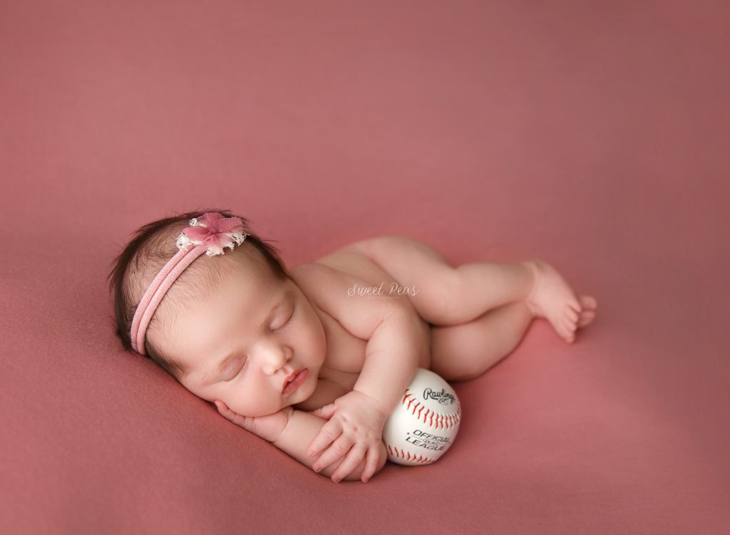 Baby girl with baseball